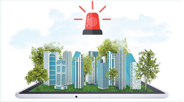 Grafik einer Stadt mit Hochhäusern in Miniatur auf einem Tablet mit roter Alarmlampe darüber